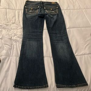 AE brand low rise boot cut jean in blue,size 4 petite, next level stretch.